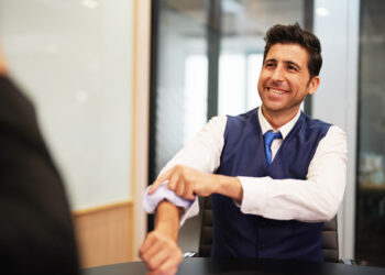 Diverse corporate team working together in modern meeting room office.