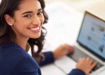 My business is on the up and up. Cropped portrait of a young businesswoman working on her laptop