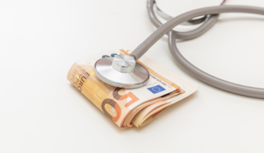 Health and medicine cost. Medical stethoscope on money, Euro banknote stack isolated on white, close up. Healthcare price in Europe