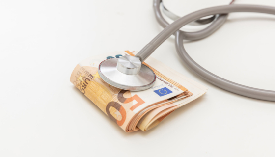 Health and medicine cost. Medical stethoscope on money, Euro banknote stack isolated on white, close up. Healthcare price in Europe