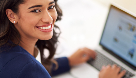 My business is on the up and up. Cropped portrait of a young businesswoman working on her laptop
